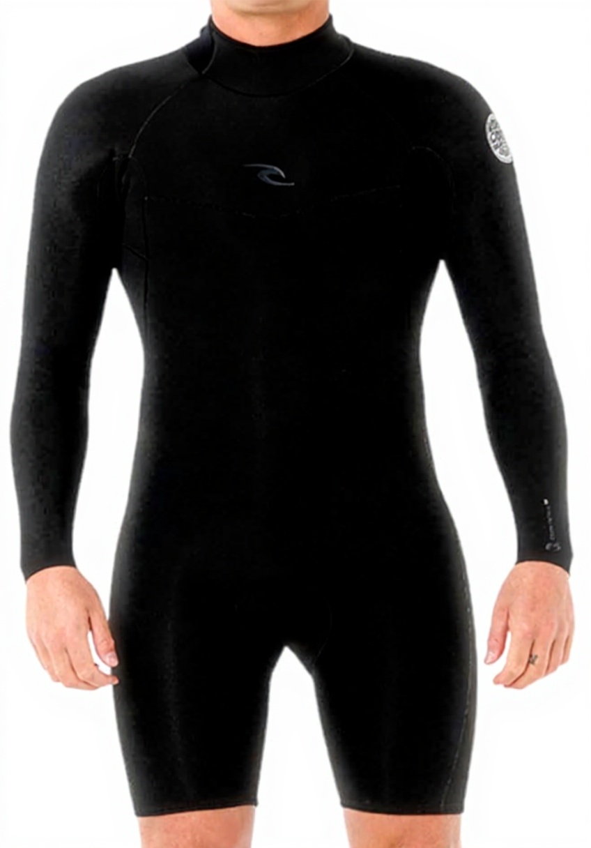 Uomo che indossa la muta shorty RIP CURL Dawn Patrol in spiaggia